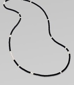 From the Night Blue Collection. This high contrast piece features a long strand of flocked velvet beads punctuated by pearlized glass beads. Length, about 49½ Slip-on style Imported 