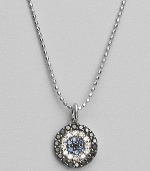 Rings of mysterious black diamonds, sparkling white diamonds and cool blue sapphires make a glamorous pendant set in 14k white gold. Diamonds, 0.26 tcw Sapphires 14k white gold Chain length, about 16 Medallion diameter, about ½ Lobster clasp Imported