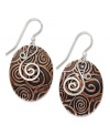 You'll be entranced by Jody Coyote's hypnotic style. Swirls of sterling silver combine with engraved copper on these oval-shaped drop earrings. Approximate drop: 1-1/2 inches.