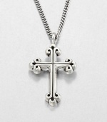 A traditional cross pendant rendered in fine sterling silver with a curb link chain necklace exudes timeless appeal.Sterling silverLength about 24Lobster claspMade in USA