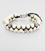 From the Spirited Bead Collection, this two-row beaded bracelet is handsomely crafted from 8mm river stone beads, featuring three silver monkey fist beads and an adjustable clasp.Sterling silverRiver stoneAbout 9 longAbout 3 diam.Imported