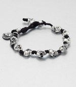 Knotted cord bracelet is interupted with impeccably sculpted skulls of sterling silver for a modern, masculine addition to your accessory collection.Sterling silverWaxed cottonDiameter, about 3Drawstring closureMade in USA