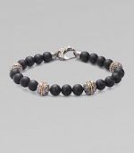 A bold statement in sterling silver and matte onyx with handsome engraved detail. Sterling silver Onyx 8mm beads About 9 long Imported 