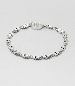 Incredibly defined skulls and crossbones are neatly designed in gleaming sterling silver for a rugged, yet refined approach to masculine, motif bracelet.Sterling silverDiameter, about 3Lobster claspMade in USA