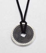 From the Classic Chain Collection. The center of this striking pendant has the look of an ancient coin with its square hole and blackened finish, set in a distinctive carved setting of polished sterling silver and hanging from a black cord.Sterling silverBlack fabric cordCord length, about 22 to 24 (adjustable)Pendant diameter, about 1.75Lobster claspMade in Bali