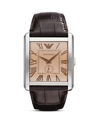 Heritage style informs this Emporio Armani watch, which flaunts a sleekly styled rectangular face, silver matte dial, and croc-embossed leather strap. Heritage style informs this Emporio Armani watch, which flaunts a sleekly styled rectangular face, silver matte dial, and croc-embossed leather strap.