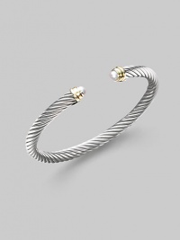 From the Cable Classics Collection. A signature Yurman cable of sterling silver, richly enhanced by white freshwater pearl end caps banded in 14k gold. White freshwater pearls Sterling silver and 14k yellow gold Cable, 5mm Diameter, about 2¼ Imported