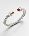 From the Cable Classics Collection. Dazzling diamonds accent this signature sterling silver cable design with carnelian end caps. CarnelianDiamonds, .48 tcwSterling silverDiameter, about 2Slip-on styleImported 