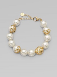 An exquisite strand of pearls accented with 18k gold flower cup caps.14mm round white organic man-made pearls18k goldplated sterling silverLength, about 7½ Lobster clasp closureImported An exquisite strand of pearls accented with 18k gold flower cup caps.14mm round white organic man-made pearls18k goldplated sterling silverLength, about 7½ Lobster clasp closureImported