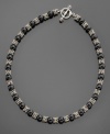 Sultry black onyx beads (8.5-9mm) swathed in sterling silver and 14k gold accents give your neckline glitter. Necklace measures 18.