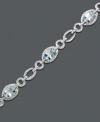 Inspired by crystal clear ocean waves. Luminous oval-cut aquamarine (5 ct. t.w.) shines as brightly as the diamond-accented oval links of this bracelet crafted from sterling silver. Approximate length: 7 inches.