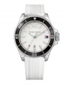 A classic sport watch by Tommy Hilfiger, perfect for the field, court or green. White rubber strap and round silvertone mixed metal case. Rotating black bezel with white numerals and stick indices. White dial features silvertone stick indices, luminous hands, numeral at twelve o'clock, iconic flag logo at three o'clock and date window at six o'clock. Quartz movement. Water resistant to 30 meters. Ten-year limited warranty.