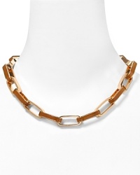 Modern elegance from MARC BY MARC JACOBS: interlocking rose gold links embellished with sleek brown enamel and a bold turnlock closure. Modern elegance from MARC BY MARC JACOBS: interlocking rose gold links embellished with sleek brown enamel and a bold turnlock closure.