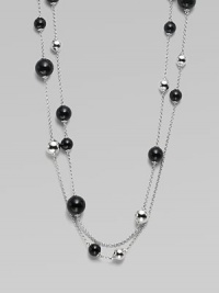 A very long, delicate piece with beautiful round black agate and contrasting sterling silver stations on a link chain, perfect for wearing doubled. Black agateSterling silverLength, about 51Clasp closureImported 