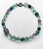 A colorful strand of flourite beads accented with a amethyst encrusted bead. AmethystMulti-colored flouriteRhodium-plated sterling silverLength, about 18Spring ring closureImported 