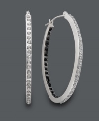 Striking contrast. Non-traditional hoops will turn heads with white diamond accents on the outside and bold, black diamond accents on the inside. Crafted in 14k white gold. Approximate diameter: 1-1/2 inches. Striking contrast. Non-traditional hoops will turn heads with white diamond accents on the outside and bold, black diamond accents on the inside. Crafted in 14k white gold. Approximate diameter: 1-1/2 inches.