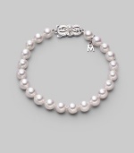 From the Akoya Collection. A simple strand of lustrous white cultured Akoya pearls with a signature filigree clasp. 7mm white, round cultured pearls Quality: A1 18k white gold Length, about 7 Mikimoto signature clasp Imported