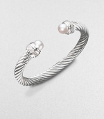 From the Silver Ice Collection. A signature Yurman cable of sterling silver, richly enhanced by bands of pavé diamonds encircling lustrous white freshwater pearl end caps. Diamonds, 0.48 tcw White freshwater pearls Sterling silver Cable, 7mm Diameter, about 2¼ Made in USA