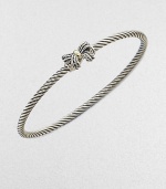 A charming, sterling silver cable design with a radiant 18k gold accented bow. Sterling silver18k goldDiameter, about 2½Slip-on styleImported 