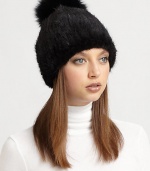 Destined to turn heads, a natural mink hat with a plush, dyed fox-fur pom pom. Dry clean by fur specialistImportedMink fur origin: DenmarkFox fur origin: China