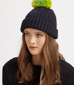 A cozy knit topper with a bold pom-pom for a simple, yet stylish, accessory.7 longMerino woolHand washImported