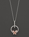 A dainty diamond butterfly pendant set in 14K. rose and white gold.