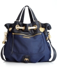 A casual silhouette with oh-so gorgeous detailing. The Spectator Teddy Bag from R&Em features shiny goldtone hardware, an optional crossbody strap and a rope detailed drawstring top. A casual silhouette with oh-so gorgeous detailing. The Spectator Teddy Bag from R&Em features shiny goldtone hardware, an optional crossbody strap and a rope detailed drawstring top.