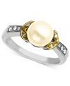 A solitary cultured freshwater pearl (7 mm) surrounded by diamond accents makes for a regal, eye-catching ring. Set in 14k gold and sterling silver. Size 7.