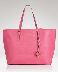 Join the jet set with this Saffiano leather tote from MICHAEL Michael Kors. Its roomy silhouette holds all your travel essentials, so carry it when it's time to take off. Join the jet set with this Saffiano leather tote from MICHAEL Michael Kors. Its roomy silhouette holds all your travel essentials, so carry it when it's time to take off.