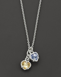 A twin heart necklace in canary crystal and blue quartz framed in sterling silver. Designed by Judith Ripka. A twin heart necklace in canary crystal and blue quartz framed in sterling silver. Designed by Judith Ripka.