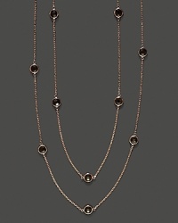 Eighteen bezel set smoky quartz stations sparkle in a long, loopable 14K rose gold chain.