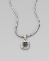 A square pendant with a sparkling black sapphire center on a braided sterling silver chain. Black sapphiresSterling silverLength, about 18Pendant size, about 1½ Lobster clasp closureImported 