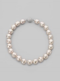 A dramatic yet simple strand of white baroque pearls, with a sparkling clasp of cubic zirconia. 16mm white man-made organic pearls Length, about 17 Sterling silver and cubic zirconia ball clasp Made in Spain A dramatic yet simple strand of white baroque pearls, with a sparkling clasp of cubic zirconia. 16mm white man-made organic pearls Length, about 17 Sterling silver and cubic zirconia ball clasp Made in Spain