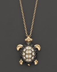 Black and white diamonds set in a 14K. yellow gold turtle pendant. Black and white diamonds set in a 14K. yellow gold turtle pendant.