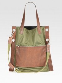 This charming carryall of sturdy resilient nylon and leather will protect and tote all of your essentials in style with an exterior zip pocket, three interior tech compartments and a detachable shoulder strap for maximum versatility.Double top handlesAdjustable shoulder strapExterior, interior zip pockets90% nylon/10% leather18W x 18H x 1DImported This charming carryall of sturdy resilient nylon and leather will protect and tote all of your essentials in style with an exterior zip pocket, three interior tech compartments and a detachable shoulder strap for maximum versatility.Double top handlesAdjustable shoulder strapExterior, interior zip pockets90% nylon/10% leather18W x 18H x 1DImported