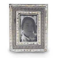 Handmade in sand-cast aluminum with a trademark blend of enamel infused with crushed mother of pearl, Julia Knight's classic picture frame features beautiful mosaic borders made of handcut Mother of Pearl tiles. Black velvet trims the back for an elegant look. Handmade in sand-cast aluminum with a trademark blend of enamel infused with crushed mother of pearl, Julia Knight's classic picture frame features beautiful mosaic borders made of handcut Mother of Pearl tiles. Black velvet trims the back for an elegant look.