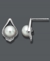 Define your style with subtle studs. Crafted in sterling silver, these petite, cultured freshwater pearls (7-8 mm) shine in a diamond-accented, sterling silver teardrop setting. Approximate diameter: 1/2 inch.