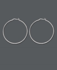 Chic, versatile style with a designer edge. Traditional hoop earrings feature an intricate diamond-cut pattern. Crafted in sterling silver. Approximate diameter: 2 inches. Chic, versatile style with a designer edge. Traditional hoop earrings feature an intricate diamond-cut pattern. Crafted in sterling silver. Approximate diameter: 2 inches.