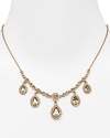Dress up a simple look or go all out and sparkly with this gleaming drop necklace from Carolee. This piece features crystal-adorned teardrops for a notice-me neckline.
