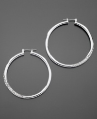 GUESS dresses up classic hoop earrings with sparkling pave crystal details. Crafted in silvertone mixed metal. Approximate diameter: 1-1/2 inches. GUESS dresses up classic hoop earrings with sparkling pave crystal details. Crafted in silvertone mixed metal. Approximate diameter: 1-1/2 inches.