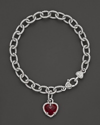 A faceted red corundum heart charm decorates a classic bracelet from Judith Ripka. A faceted red corundum heart charm decorates a classic bracelet from Judith Ripka.
