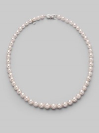 A classic strand of graduated white Akoya pearls with a pretty filigree clasp. 7mm- 9mm white round cultured pearls Quality: A1 18k white gold Length, about 18 Mikimoto signature clasp Imported