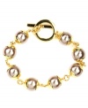 Elegance in an instant. This bracelet by AK Anne Klein features chic plastic pearl beads and toggle clasp. Crafted in gold tone mixed metal. Approximate length: 7-3/4 inches.