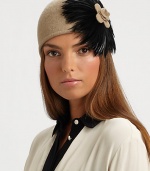 This wool-blend knit topper with large feather design is reminiscent of old Hollywood style.Pull-on style with concealed elastic band80% wool/20% polyesterDo not washImported