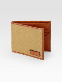Crafted from canvas with leather trim, this sleek wallet features ample storage and a signature embossed leather logo patch for a refined finish.One billfold walletEight card slotsOne ID windowRectangular silhouette with single-needle stitching around the leather perimeterEmbossed logo at the interiorPRL-embossed leather logo patch accents the exteriorCanvas4W x 4HImported Crafted from canvas with leather trim, this sleek wallet features ample storage and a signature embossed leather logo patch for a refined finish.One billfold walletEight card slotsOne ID windowRectangular silhouette with single-needle stitching around the leather perimeterEmbossed logo at the interiorPRL-embossed leather logo patch accents the exteriorCanvas4W x 4HImported