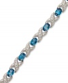 The perfect gift. Both symbolic and stylish, this XO tennis bracelet features oval-cut London blue topaz (7-1/2 ct. t.w.) and sparkling diamond accents in sterling silver. Approximate length: 7 inches.