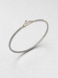 From the Cable Collectibles Collection. A graceful fleur de lis with gold accents forms the centerpiece of this classic cable bangle.Sterling silver and 18k yellow goldCable, 3mmDiameter, about 2.25Imported From the Cable Collectibles Collection. A graceful fleur de lis with gold accents forms the centerpiece of this classic cable bangle.Sterling silver and 18k yellow goldCable, 3mmDiameter, about 2.25Imported