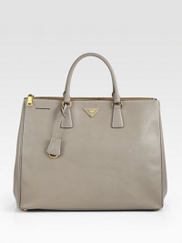 Sumptuous saffiano leather in a top-handle carryall with metal logo detail.Double top handles, 5 dropDouble top zip compartmentsKey tagProtective metal feetOne inside zip pocketThree inside open pocketsFully lined15½W X 12H X 7DMade in Italy Sumptuous saffiano leather in a top-handle carryall with metal logo detail.Double top handles, 5 dropDouble top zip compartmentsKey tagProtective metal feetOne inside zip pocketThree inside open pocketsFully lined15½W X 12H X 7DMade in Italy