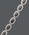 Revel in luxurious links. This oval-shaped bracelet features sparkling black diamonds (1/4 ct. t.w.) and white diamonds (1/4 ct. t.w.) brought together for chic contrast. Set in sterling silver. Approximate length: 7-1/4 inches.