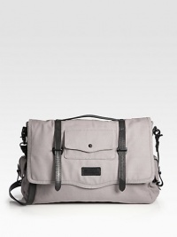 Run around town in style with this canvas messenger with leather trim and an array of exterior and interior pockets for added versatility.Flap, snap button closureTop handleAdjustable shoulder strapExterior, interior pocketsFully linedCanvas8W x 12H x 6DImported Run around town in style with this canvas messenger with leather trim and an array of exterior and interior pockets for added versatility.Flap, snap button closureTop handleAdjustable shoulder strapExterior, interior pocketsFully linedCanvas8W x 12H x 6DImported